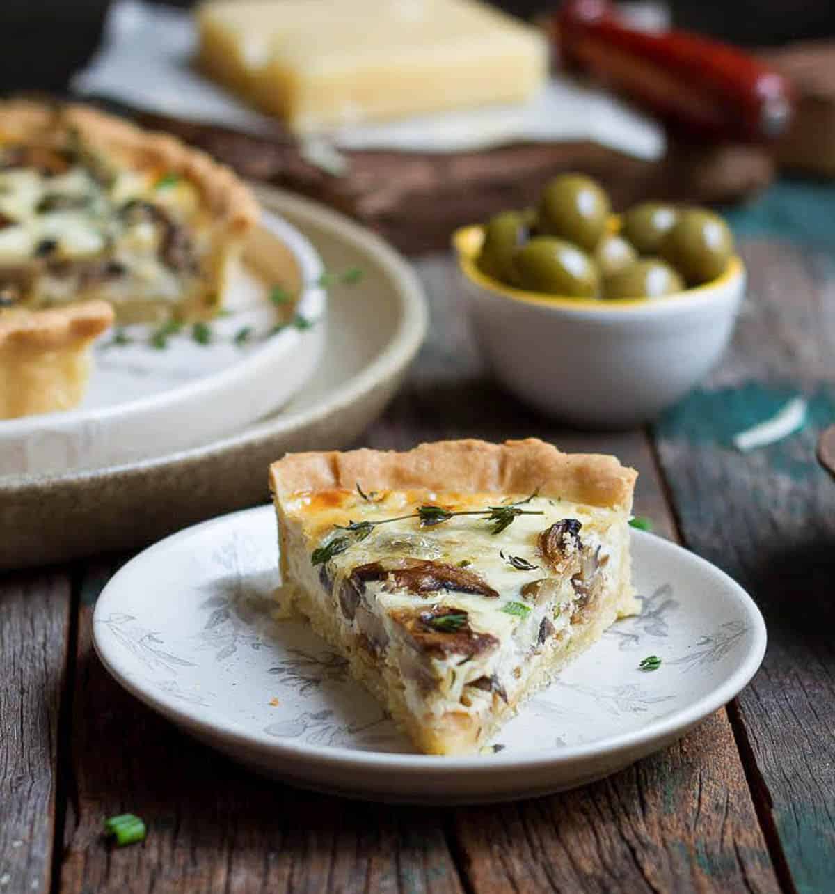 a slice of mushroom quiche on a small plate.