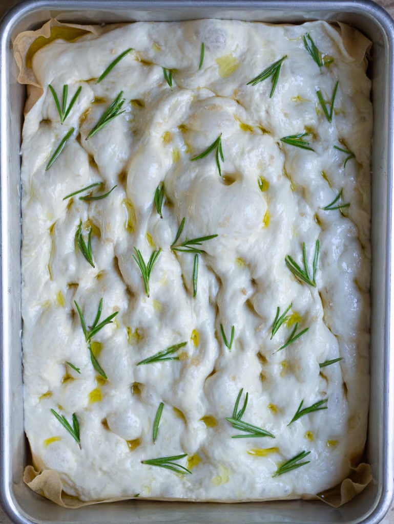 Put olive oil, rosemary, and sea salt on the dough before baking