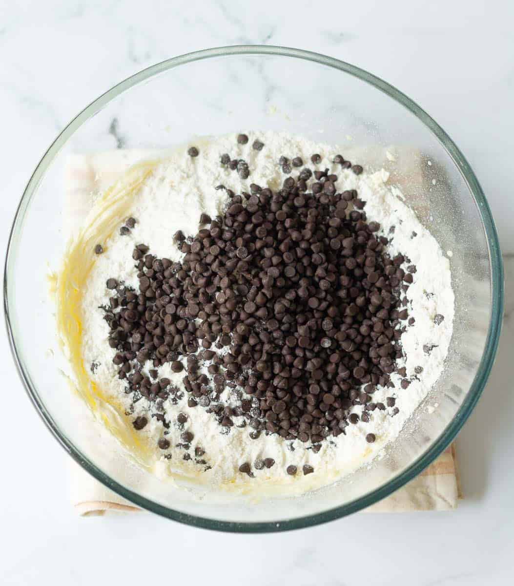 Flour and chocolate chip added to a mixture of butter and icing sugar